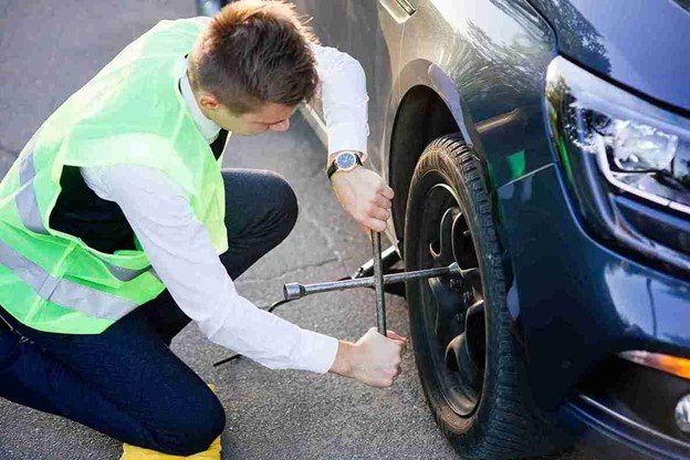 Cuyahoga Towing Service changing a tire on the roadside